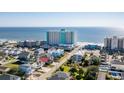 Oceanfront high-rise with nearby houses and beach access at 1210 N Waccamaw Dr. # 404, Garden City Beach, SC 29576