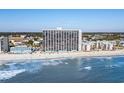 High-rise building on the beach with ocean view and beachgoers at 1210 N Waccamaw Dr. # 404, Garden City Beach, SC 29576