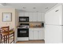 Small galley kitchen with white cabinets and standard appliances at 2501 S Ocean Blvd. # 1111, Myrtle Beach, SC 29577