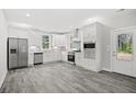 Modern kitchen featuring white cabinets, stainless steel appliances, and grey tile floors at 5575 Dinkler Ave., Loris, SC 29569
