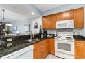 Modern kitchen featuring granite countertops and white appliances at 2100 Sea Mountain Hwy. # 200, North Myrtle Beach, SC 29582