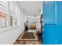 Bright entryway with blue door, hardwood floors, and a view into the living room at 4739 Cloisters Ln., Myrtle Beach, SC 29577
