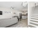 Open living area with gray couches, kitchen island, and staircase at 606 29Th Ave. S, North Myrtle Beach, SC 29582