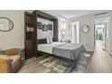 Bedroom with a queen bed, built in shelving, and a murphy bed at 7500 Ocean Blvd. N # 6010, Myrtle Beach, SC 29572