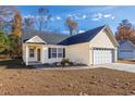 House exterior showcasing a yellow vinyl-sided home with a gray roof and landscaping at 1108 Patricia Ct., Conway, SC 29526