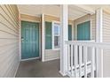 Exterior view of building entrance with teal door and white railing at 1109 Blue Stem Dr. # 34D, Pawleys Island, SC 29585