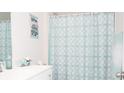 Clean bathroom with a teal shower curtain and white vanity at 1448 Greenock Ln., Conway, SC 29526