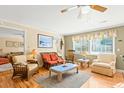 Living room with wicker furniture, hardwood floors, and coastal decor at 431 28Th St. S, Sunset Beach, NC 28468