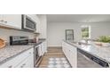 Modern kitchen with white cabinets, granite countertops, and stainless steel appliances at 5004 Yellowstone Dr., Conway, SC 29526