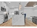 Modern kitchen featuring white cabinets, marble island, and stainless steel appliances at 6703 Ocean Breeze Loop, Myrtle Beach, SC 29577