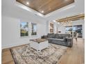 Spacious living room with hardwood floors, wood beams, and a large chandelier at 6703 Ocean Breeze Loop, Myrtle Beach, SC 29577