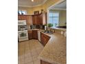 Spacious kitchen featuring Corian countertops and wooden cabinetry at 729 Woodcrest Way, Murrells Inlet, SC 29576