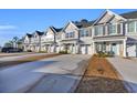 Row of townhouses showcasing attached garages and landscaping at 2357 Elowen Ln. # 12C, Longs, SC 29568