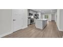Modern kitchen with island, stainless steel appliances, and hardwood floors at 2357 Elowen Ln. # 12C, Longs, SC 29568