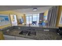 Kitchen with granite countertops and stainless steel sink at 2701 S Ocean Blvd. # 809, North Myrtle Beach, SC 29582