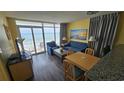 Living room with ocean view, balcony access, and seating area at 2701 S Ocean Blvd. # 809, North Myrtle Beach, SC 29582
