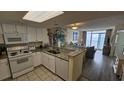 Well-equipped condo kitchen with granite countertops and white cabinets at 2711 S Ocean Blvd. # 1937, North Myrtle Beach, SC 29582