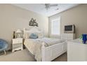 Bright bedroom with white furniture and a TV at 4519 N Plantation Dr. # X-9, Little River, SC 29566