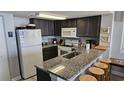 Granite countertops, dark cabinets, and modern appliances at 501 S Ocean Blvd. # 601, North Myrtle Beach, SC 29582