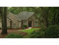 Brick house nestled in a lush, wooded area at 1262 Limestone St., Murrells Inlet, SC 29576