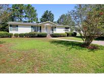 Charming single-story home with well-manicured lawn at 894 S Marlin Circle, Murrells Inlet, SC 29576
