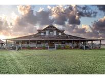 Rustic two-story home with wrap-around porch and expansive lawn at 3215 Bluff Rd., Marion, SC 29571