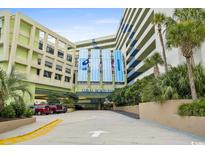 Exterior view of Coral Beach Resort, showing the building and parking area at 1105 S Ocean Blvd. # 630, Myrtle Beach, SC 29577