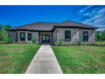 Brick home with gray siding, dark windows, and a walkway leading to the entrance at 209 Brush Ct., Little River, SC 29566
