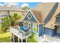 Blue house with a deck, showcasing modern design and outdoor living space at 902 Sea Mountain Hwy. # 10, North Myrtle Beach, SC 29582