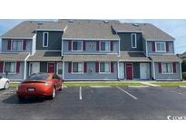 Three-story building with gray and burgundy accents at 1880 Colony Dr. # 12-F, Surfside Beach, SC 29575