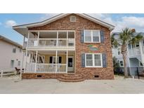 Brick two-story house with front porch and balcony at 1418 S Ocean Blvd., North Myrtle Beach, SC 29582