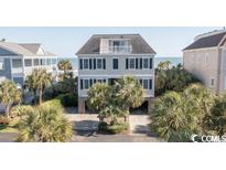 Beautiful oceanfront home with three floors and private driveway at 230 Sea Oats Circle, Pawleys Island, SC 29585