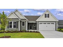 Two-story house with gray siding and a two-car garage at 1906 Woodrush Loop, Little River, SC 29566