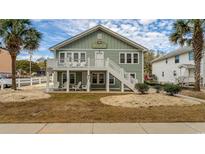 Two-story house with a green exterior, deck, and landscaping at 1906 S Ocean Blvd., North Myrtle Beach, SC 29582