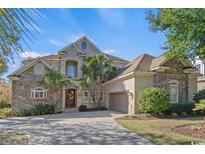 Two-story brick home with stone accents and landscaping at 507 Seafarer Way, North Myrtle Beach, SC 29582