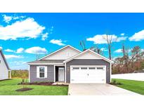 Gray house with white garage door and landscaping at 108 Little Cedar Dr., Loris, SC 29569