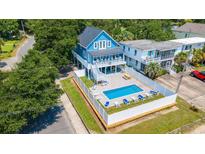 Blue house with a pool and patio in a residential neighborhood at 304 2Nd Ave. S, North Myrtle Beach, SC 29582