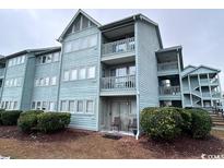 Three-story light blue building with balconies and landscaping at 5905 South Kings Hwy. # 6110-D, Myrtle Beach, SC 29575