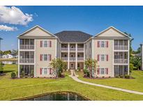 Two-story condo building with pond view and walkway at 2050 Cross Gate Blvd. # 303, Myrtle Beach, SC 29575