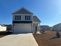 Two-story house with gray siding,attached garage, and a landscaped yard at 711 Canton St., Conway, SC 29526