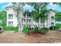Two-story building exterior with lush landscaping at 9550 Dunes Gable Dr. # C, Myrtle Beach, SC 29572