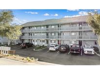 Exterior view of a multi-unit building with ample parking at 7700 Porcher Dr. # 3207, Myrtle Beach, SC 29572