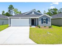 Gray house with white garage door, landscaping, and a blue door at Tbd Cherrystone Loop, Conway, SC 29526