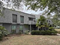 Two-story building exterior with grey siding and a balcony at 178 Salt Marsh Circle # 30F, Pawleys Island, SC 29585