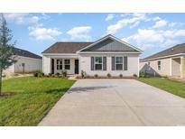 Charming one-story home with gray accents and a spacious driveway at 1756 Whispering Pine St., Ocean Isle Beach, NC 28469