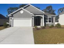 Gray sided house with white garage door and landscaping at 108 Fair Meadow Ct., Loris, SC 29569