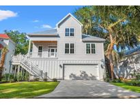 Two story home with gray siding and metal roof at 596 Collins Ave., Murrells Inlet, SC 29576