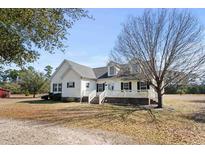 White house exterior with a wraparound porch at 589 Loop Circle, Longs, SC 29568