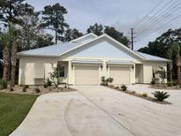 Cream and light blue two-unit house with two garages at 132 Hallandale Lane # Left, Murrells Inlet, SC 29576