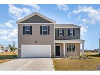 Two-story home with gray and beige siding, white garage door at 776 Planters Moon Dr., Galivants Ferry, SC 29544